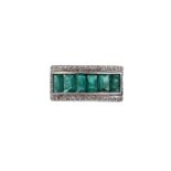 AN EMERALD AND DIAMOND PANEL RING