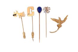 A COLLECTION OF FOUR STICK PINS AND A BIRD OF PARADISE BROOCH