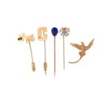 A COLLECTION OF FOUR STICK PINS AND A BIRD OF PARADISE BROOCH