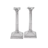 A PAIR OF SILVER CORINTHIAN CANDLESTICKS