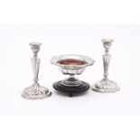 A PAIR OF CONTINENTAL SILVER COLOURED CANDLESTICKS