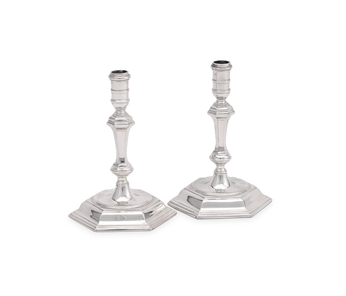 A PAIR OF CAST SILVER TAPERSTICKS