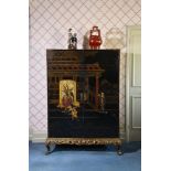 A BLACK LACQUER AND GILT CHINOISERIE DECORATED CUPBOARD OR WARDROBE, CIRCA 1930