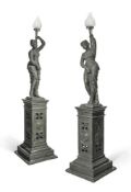 A PAIR OF GREEN PAINTED CAST IRON FEMALE FIGURAL TORCHERES IN THE MANNER OF DURENNE PROBABLY FRENCH