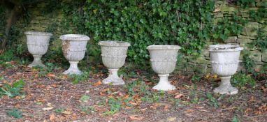 A SET OF FIVE STONE COMPOSTION URNS, IN 19TH CENTURY STYLE, 20TH CENTURY