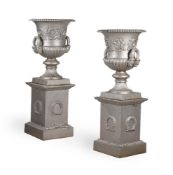 A PAIR OF HANDYSIDE PATTERN CAST IRON URNS AND PEDESTALS, LATE 19TH CENTURY