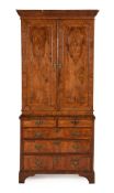 A GEORGE II WALNUT AND FEATHER BANDED CABINET ON CHEST, CIRCA 1740
