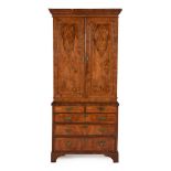 A GEORGE II WALNUT AND FEATHER BANDED CABINET ON CHEST, CIRCA 1740