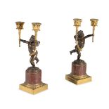 A PAIR OF FRENCH PATINATED, GILT BRONZE AND ROUGE GRIOTTE MARBLE MOUNTED FIGURAL CANDELABRA