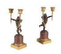 A PAIR OF FRENCH PATINATED, GILT BRONZE AND ROUGE GRIOTTE MARBLE MOUNTED FIGURAL CANDELABRA