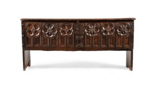 A CARVED OAK COFFER, IN GOTHIC STYLE, MID 17TH CENTURY AND LATER