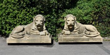 A PAIR OF LARGE COMPOSITION STONE LIONS, IN THE MANNER OF THE HADDONSTONE LEAZES PARK LIONS, MODERN