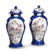 A LARGE PAIR OF BLUE GROUND FAMILLE ROSE VASES, 20TH CENTURY