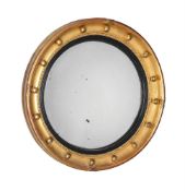 A REGENCY GILTWOOD CONVEX WALL MIRROR, IN THE MANNER OF THOMAS FENTHAM, CIRCA 1820