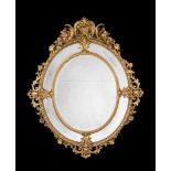 A CARVED GILTWOOD AND GESSO OVAL WALL MIRROR, MID 19TH CENTURY