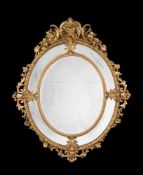 A CARVED GILTWOOD AND GESSO OVAL WALL MIRROR, MID 19TH CENTURY