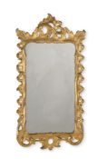 AN EARLY GEORGE III CARVED GILTWOOD WALL MIRROR, CIRCA 1760