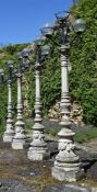 A SET OF FOUR NEOCLASSICAL STYLE LAMP POSTS, MODERN