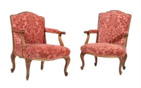 TWO WALNUT AND RED VELVET UPHOLSTERED OPEN ARMCHAIRS