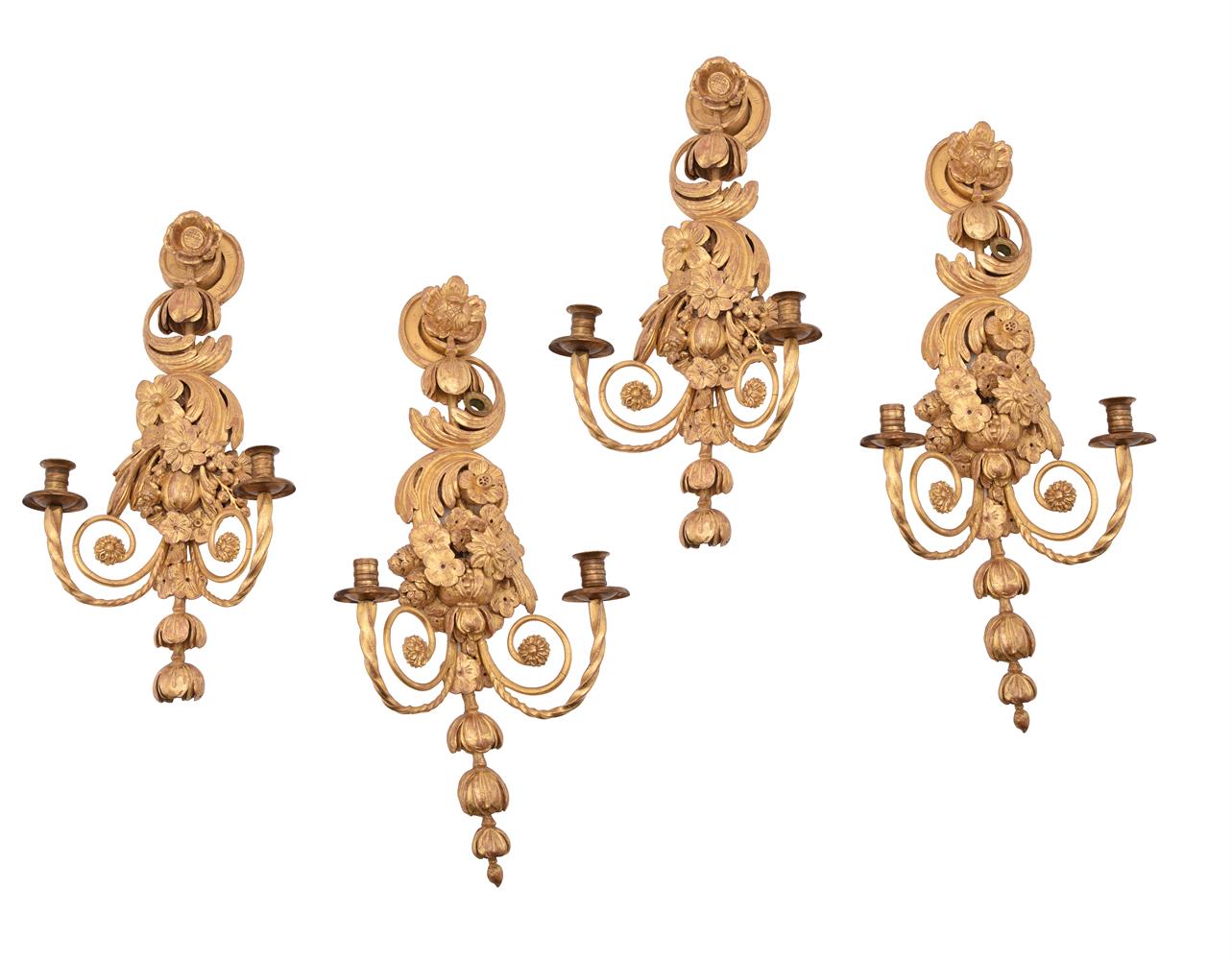 A SET OF FOUR CARVED GILTWOOD WALL APPLIQUES