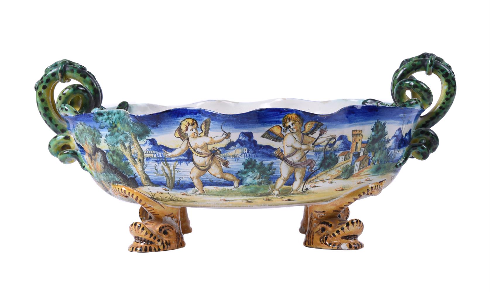 A ULISSE CANTAGALLI MAIOLICA TWO-HANDLED OVAL DISH WITH FOUR DOLPHIN FEET