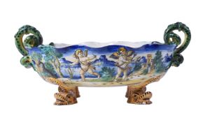 A ULISSE CANTAGALLI MAIOLICA TWO-HANDLED OVAL DISH WITH FOUR DOLPHIN FEET