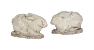 A PAIR OF PAINTED COMPOSITE STONE MODELS OF WHITE RABBITS, 20TH CENTURY