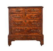 A WALNUT AND INLAID CHEST OF DRAWERS