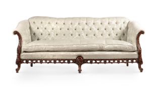 A CARVED WALNUT AND UPHOLSTERED SOFA