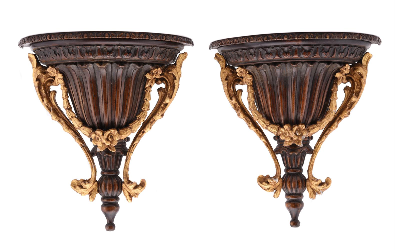 A PAIR OF MAHOGANY AND PARCEL GILT WALL BRACKETS