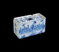 AN ENGLISH DELFT CHINOISERIE BLUE AND WHITE FLOWER BRICK