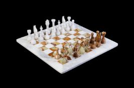 A MODERN CARVED STONE CHESS SET