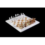 A MODERN CARVED STONE CHESS SET