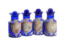 A SET OF FOUR BLUE GLASS AND ENAMELLED APOTHECARY JARS