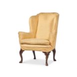 A WALNUT AND UPHOLSTERED WING ARMCHAIR, CIRCA 1740 AND LATER
