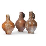 A GROUP OF THREE GERMAN SALT-GLAZED STONEWARE BOTTLE FLASKS, 17TH CENTURY