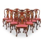 A SET OF EIGHT GEORGE II WALNUT AND PARCEL GILT DINING CHAIRSCIRCA 1730With repeating eagle motifs