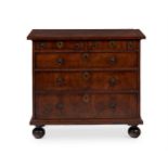 A WALNUT CHEST OF DRAWERS , OF 'BACHELOR' TYPE, EARLY 18TH CENTURY AND LATER