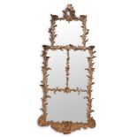 AN EARLY GEORGE III CARVED PINE AND CARTON PIERRE WALL MIRROR, CIRCA 1760
