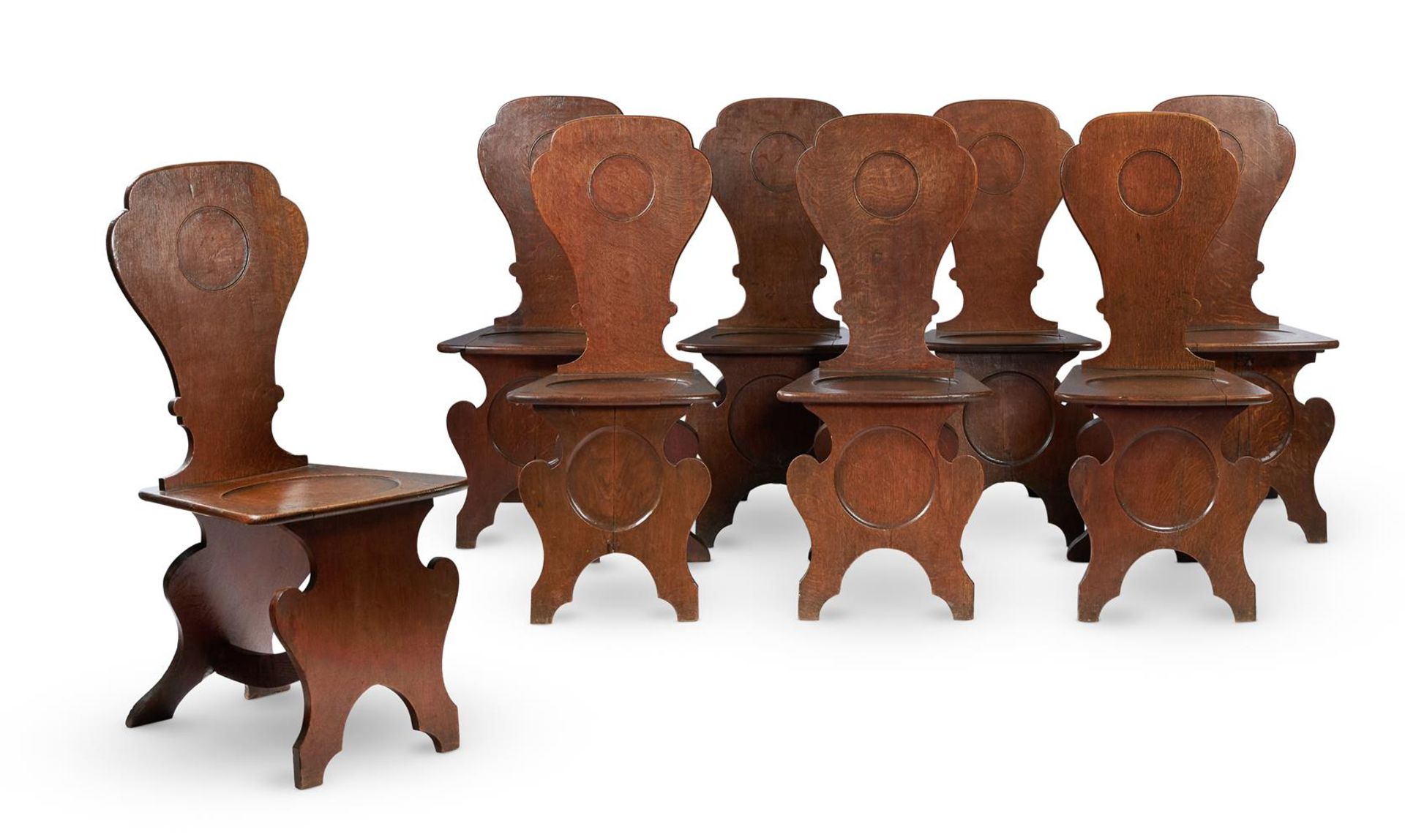 A SET OF EIGHT GEORGE III OAK HALL CHAIRS, CIRCA 1780