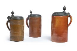 THREE GERMAN STONEWARE PEWTER-MOUNTED TANKARDS AND HINGED COVERS, 17TH/18TH CENTURY