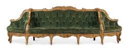 A LARGE CONTINENTAL CARVED GILTWOOD SOFA OR CANAPE A CONFIDENTS, MID 18TH CENTURY
