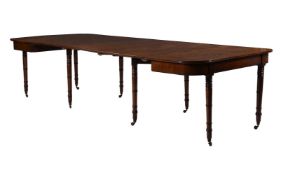 A REGENCY MAHOGANY AND PARCEL EBONISED EXTENDING DINING TABLE