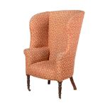 A MAHOGANY AND UPHOLSTERED BARREL BACK ARMCHAIR