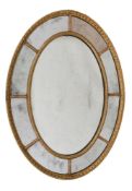 A GILTWOOD AND GESSO OVAL WALL MIRROR