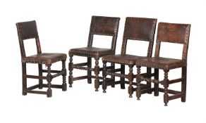 A HARLEQUIN SET OF EIGHT OAK AND LEATHER UPHOLSTERED CHAIRS