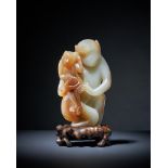 A rare Chinese pale celadon and brown jade model of a 'monkey and infant'