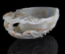 A Chinese celadon and russet jade carved peach-form water pot