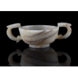 A Chinese white and russet jade archaistic cup