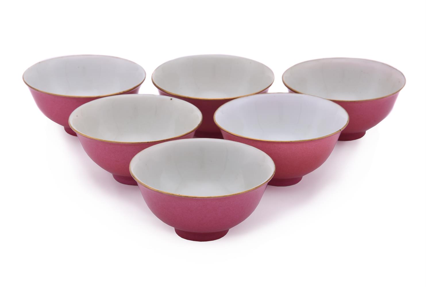 A set of six small ruby-red bowls